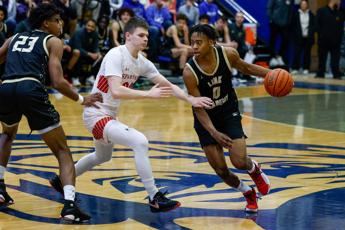 Link Academy senior Tre Johnson dribbles around a screen in Link Academy's win against The Burlington School (North Carolina) at the Quincy Shootout on Jan. 20, 2024.